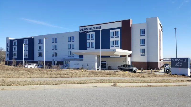 A new four-story hotel with a covered front entrance.