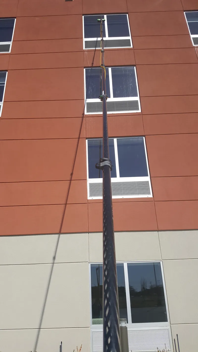 A water-fed pole reaching the upper-floor windows of a hotel.